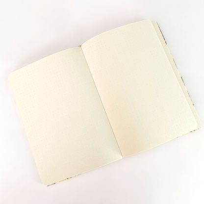 Rambunctious Raccoons hardcover dot grid journal by Allison Stoiser Art, featuring colorful raccoon illustrations on the cover.