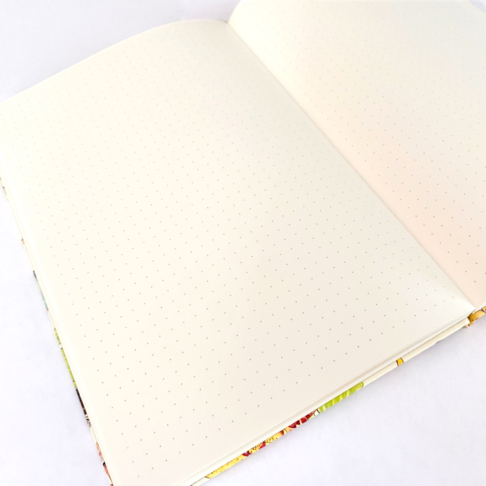 Hardcover Rambunctious Raccoons Dot Grid Journal by Allison Stoiser Art featuring playful raccoon illustrations on the cover.