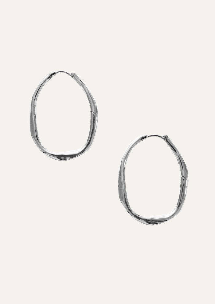 A pair of large sterling silver hoop earrings.