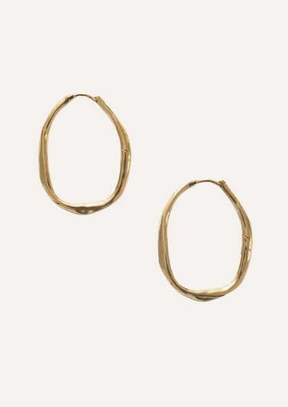 A pair of large gold hoop earrings.