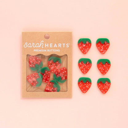 Six large strawberry-shaped buttons from Sarah Hearts, colorful accessories with detailed fruit design.