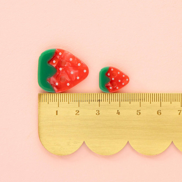 Small 5/8 inch strawberry-shaped buttons from Sarah Hearts, perfect for accessories and craft projects.