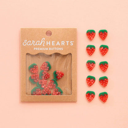 Pair of small 5/8-inch strawberry-shaped buttons from Sarah Hearts, perfect for accessories and craft projects.
