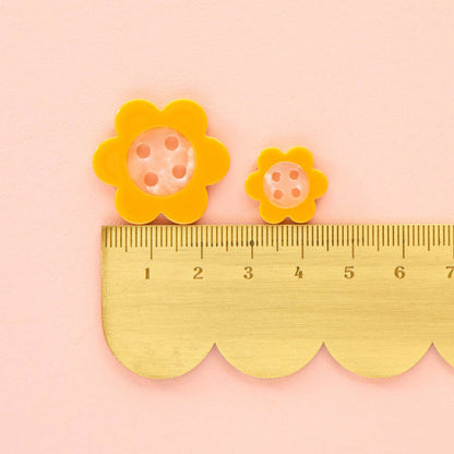Yellow Daisy Large 1-inch buttons by Sarah Hearts, colorful floral accessory buttons with yellow petals and white centers.